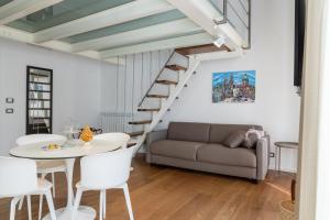 a living room with a couch and a table at Peonia Boutique Apartments in Palermo