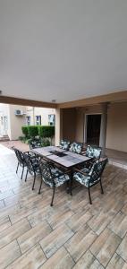 a wooden table and chairs on a patio at Crayfish Creek Guest House in Richards Bay