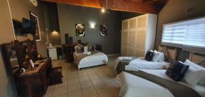 a large room with two beds and a couch at Crayfish Creek Guest House in Richards Bay