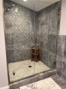 a shower with a glass door in a bathroom at Cheerful 5-bedroom w/Screened Patio, Sleeps 10 in the heart of Fremont! in Fremont