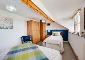 a bedroom with two beds and a window at Bryncylla in Llangurig
