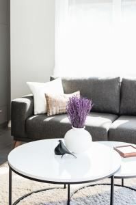 sala de estar con mesa de centro blanca y sofá en Lamira - Serviced Apartments en Zúrich