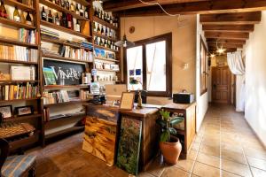 a room with a desk and shelves with books at Vinarius - Exclusiva Posada Rural con cava romana del siglo III y manantial in Castellanos de Villiquera