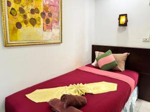 a bedroom with a bed with a towel on it at Lamai Apartment in Patong Beach