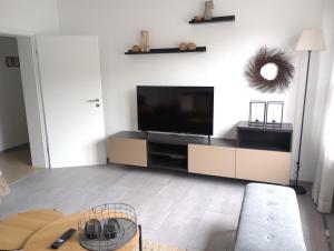 a living room with a flat screen tv on a wall at Provinzial Ferienwohnung Walter in Wadgassen