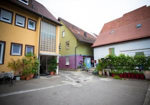 a row of colorful buildings in a parking lot at Hotel Fantastic in Neckartenzlingen
