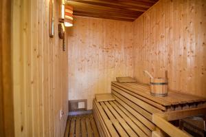 a small wooden sauna with a bucket in it at Hotel Galant Lednice in Lednice