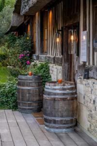 two large wooden barrels sitting outside of a building at La Chaumière in Honfleur