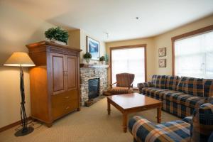 a living room with a couch and a fireplace at 3221 - Three Bedroom Standard Powderhorn Lodge condo in Solitude