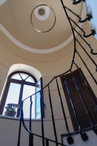 a spiral staircase with a window at Peonia Boutique Apartments in Palermo