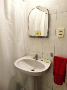 a bathroom with a sink and a mirror at Dunas del Diablo in Punta Del Diablo