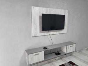 a living room with a tv on a wall at Sea Views at 10 South in Durban