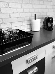 a kitchen counter with a black box on top of it at Henriett’s cosy places in Satu Mare