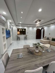 a large living room with a table and chairs at Beitk Al-ula Apartments شقق بيتك العلا in AlUla