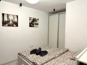 a bedroom with a bed with a black bow on it at Apartament in centrul Clujului in Cluj-Napoca +60 photos