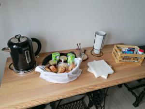 a table with a basket of bread and a coffee pot at Monte Beatriz in Reguengos de Monsaraz