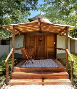 a wooden gazebo with a chair on a deck at Destino Mío by AKEN Soul 