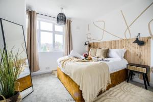 a bedroom with a bed and a large window at Coventry Stunning House, 3 double beds, Birmingham Airport NEC, Sleeps 7, by EMPOWER HOMES in Coventry