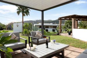 a patio with two chairs and a table on a patio at Villalaluna lacasa in Vejer de la Frontera