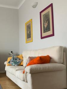 a white couch with pillows on it in a living room at Casa Gregis - Museums Area - 10 min walk to Upper town in Bergamo