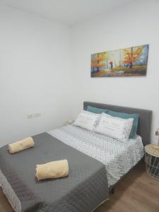 a bed with two pillows on it in a room at Chilling in Netanya in Netanya