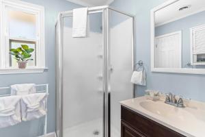 a bathroom with a shower and a sink at Gone Intracoastal in Ocean Isle Beach +27 photos
