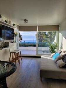 a living room with a view of the ocean at Playa Paraíso Resort in Concón