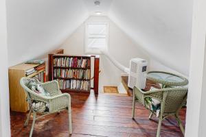 a living room with two chairs and a fan at Town of Rehoboth 20 Delaware Ave in Rehoboth Beach