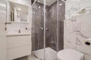 a bathroom with a shower and a toilet at K33- Boutique Apartments, Best Location, by BQA in Budapest
