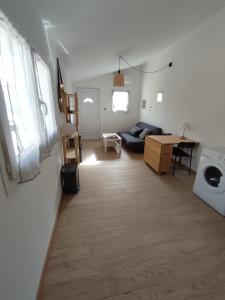 a living room with a couch and a table at Paisible maisonnette à Entraigues sur la Sorgue in Entraigues-sur-la-Sorgue