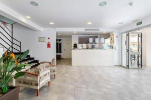 a lobby with a waiting room and a counter at Hostal Gami Adults Only in Cala Ratjada