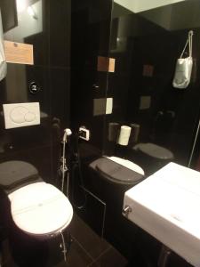 a bathroom with two toilets and a sink at Nerva Accommodation in Rome