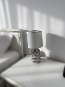 a small lamp sitting on top of a table at Star Apartments in Baia Mare