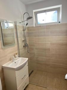 a bathroom with a shower and a sink and a mirror at Star Apartments in Baia Mare