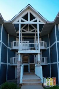 a building with a balcony and stairs on it at Horseshoe Retreat in Edgar