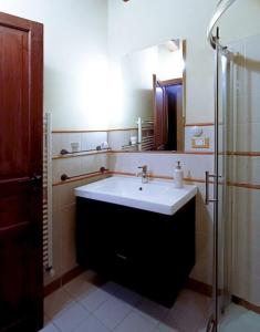 a bathroom with a large sink and a shower at Casa all'Annunziata in Termini Imerese