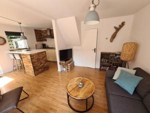 a living room with a couch and a table at Have a nice stay! - North Sea Home in Noordwijk aan Zee