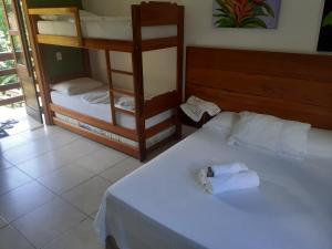 Una cama o camas en una habitación de Pousada Sol da Trindade