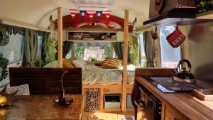 a bedroom with a bed in a tiny house at AirstreamNB in Schayk