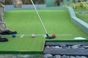 a man playing a game of golf on a putting greens at InterContinental Grand Ho Tram in Ho Tram