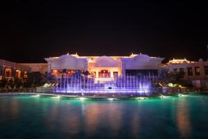 a large building with a fountain at night at InterContinental Grand Ho Tram in Ho Tram
