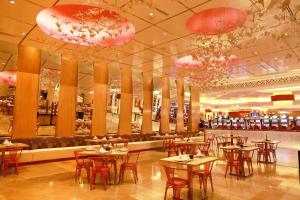 a restaurant with tables and chairs and pink chandeliers at InterContinental Grand Ho Tram in Ho Tram