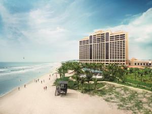 a view of a hotel and a beach with palm trees at InterContinental Grand Ho Tram in Ho Tram