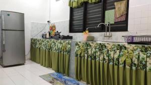 eine Küche mit einer grünen Theke und einer Spüle in der Unterkunft ISLAMIC HOMESTAY @ KUALA ROMPIN , PAHANG . in Kuala Rompin