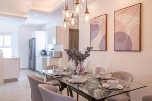 a dining room with a glass table and chairs at Family Getaway Apartment - Right On The Beach in Punta Cana