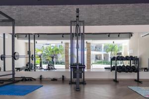 a gym with lots of equipment in a room at Family Getaway Apartment - Right On The Beach in Punta Cana