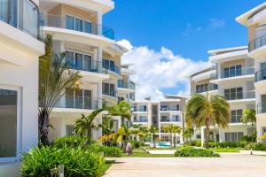 a view of the exterior of an apartment building at Family Getaway Apartment - Right On The Beach in Punta Cana