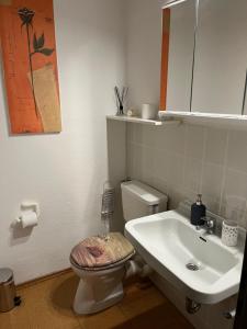 a bathroom with a toilet and a sink at Restaurant- Hotel- Biergarten Haduloha in Otterndorf