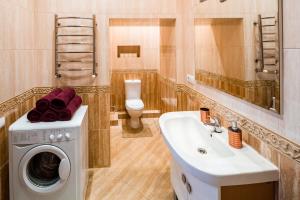 a bathroom with a washing machine and a sink at Romari Лесі Українки in Lviv +59 photos
