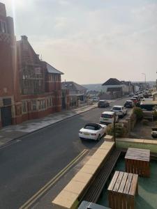 a street with cars parked on the side of the road at Kennys apartment in Milford Haven